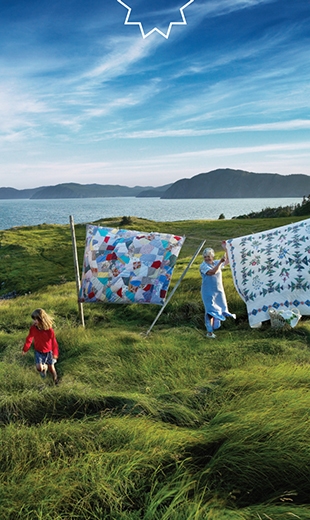 A family is placing quilts on their clothesline in Maberly.