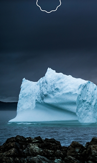 Two massive icebergs sit in the ocean in Goose Cove.