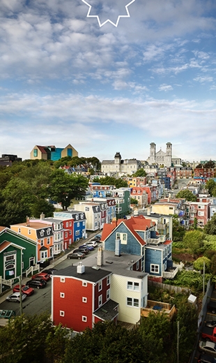 A blue sky hovers over the colourful houses in St. John’s.