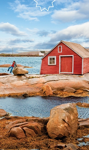 A child hops over a red rock near a red house just off the shores of Tilting.